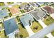 Aerial view of a home with lush landscaping, pristine lawn, and neutral gray roof at 3381 Harris Ct, The Villages, FL 32163