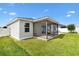 Beautifully maintained backyard featuring a screened lanai and lush, green lawn at 3381 Harris Ct, The Villages, FL 32163
