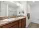 Bright bathroom featuring a double sink vanity, large mirror, and modern fixtures at 3381 Harris Ct, The Villages, FL 32163