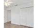 Bedroom with white walls, wood floors, a ceiling fan, and double closets at 3381 Harris Ct, The Villages, FL 32163