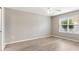 Bright bedroom with light wood-look flooring, a ceiling fan, and a window offering natural light at 3381 Harris Ct, The Villages, FL 32163