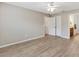 Bedroom with modern flooring, ceiling fan, access to a bathroom, and closet space at 3381 Harris Ct, The Villages, FL 32163