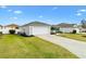 Charming single Gathering home with a well-manicured lawn and landscaped yard at 3381 Harris Ct, The Villages, FL 32163
