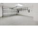 Spacious garage with epoxy flooring, shelving, and overhead door with opener at 3381 Harris Ct, The Villages, FL 32163