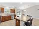 Bright kitchen area with eat-in island and stainless steel appliances, offering a view of the backyard at 3381 Harris Ct, The Villages, FL 32163