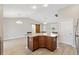 Open-concept living space with eat-in kitchen island, bright lighting, and adjacent access to other rooms at 3381 Harris Ct, The Villages, FL 32163