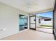 Rear screened porch with a ceiling fan and view of the privacy fenced yard at 3381 Harris Ct, The Villages, FL 32163
