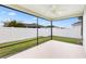 Screened in patio overlooking a fenced-in yard with ample green space at 3381 Harris Ct, The Villages, FL 32163
