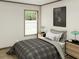 Cozy bedroom featuring a plaid comforter, natural light, and modern decor at 10129 Sw 157Th Ln, Dunnellon, FL 34432