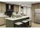 Modern kitchen featuring an island with seating, stainless steel appliances, and stylish cabinets at 10129 Sw 157Th Ln, Dunnellon, FL 34432