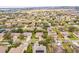 An aerial view shows a well-planned community with solar panels and landscaping at 1086 Harmony Ln, Clermont, FL 34711