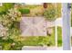 An aerial shot displaying the roof of a home with a grassy yard, and street access at 1086 Harmony Ln, Clermont, FL 34711
