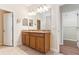 Bathroom with double vanity, granite countertops, and ample lighting at 1086 Harmony Ln, Clermont, FL 34711