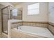 Relaxing bathroom featuring a soaking tub and a glass enclosed shower at 1086 Harmony Ln, Clermont, FL 34711
