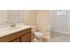 Bathroom with a single sink vanity with chrome faucet and a toilet at 1086 Harmony Ln, Clermont, FL 34711