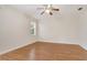 A bright bedroom with laminated wood floor and a ceiling fan at 1086 Harmony Ln, Clermont, FL 34711