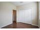 Comfortable bedroom with wood floor, base trim, closet, and window at 1086 Harmony Ln, Clermont, FL 34711