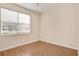 Cozy bedroom with laminated wood floor, base trim, and window with blinds at 1086 Harmony Ln, Clermont, FL 34711