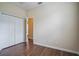 Bedroom featuring vinyl floors, double door closet and neutral walls at 1086 Harmony Ln, Clermont, FL 34711