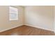 Bedroom featuring wood-look floors, neutral walls, and bright natural light at 1086 Harmony Ln, Clermont, FL 34711