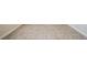 Close-up of neutral ceramic tile flooring with white baseboards at 1086 Harmony Ln, Clermont, FL 34711