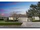 Charming one-story home featuring a three-car garage, well-manicured lawn, and welcoming front entry at 1086 Harmony Ln, Clermont, FL 34711