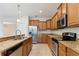 Well-equipped kitchen featuring granite countertops and stainless steel appliances at 1086 Harmony Ln, Clermont, FL 34711