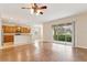Bright living room with hardwood floors and a large sliding glass door to the backyard at 1086 Harmony Ln, Clermont, FL 34711