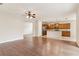 Open-concept living area with hardwood floors seamlessly connected to a well-appointed kitchen at 1086 Harmony Ln, Clermont, FL 34711
