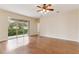 Spacious living room featuring wood flooring, a ceiling fan, and sliding glass doors at 1086 Harmony Ln, Clermont, FL 34711