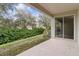 Covered patio and lush backyard landscaping viewed from the patio at 1086 Harmony Ln, Clermont, FL 34711