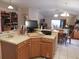 Open kitchen with tile flooring, center island, and adjacent dining area at 30126 Sandbunker Ln, Sorrento, FL 32776