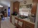 A functional kitchen featuring white appliances, wood cabinets, and tile floors at 30126 Sandbunker Ln, Sorrento, FL 32776