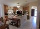 Open kitchen with tile flooring, center island, and updated appliances at 30126 Sandbunker Ln, Sorrento, FL 32776