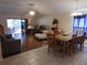 Open-concept living and dining room with wood floors and sliding door access at 30126 Sandbunker Ln, Sorrento, FL 32776