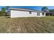 Home's exterior shows a simple backyard with a new lawn and door access at 20184 Sw 57 St, Dunnellon, FL 34431