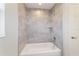 Bathroom features an enclosed shower over tub with updated tile surround and updated fixtures at 20184 Sw 57 St, Dunnellon, FL 34431