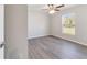 This bedroom features wood-look floors, a ceiling fan, and a window with a view of the outdoors at 20184 Sw 57 St, Dunnellon, FL 34431