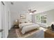 Cozy bedroom features a ceiling fan, plush rug, and lots of natural light at 20184 Sw 57 St, Dunnellon, FL 34431
