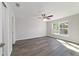 Bright bedroom features a ceiling fan and a large window for natural light at 20184 Sw 57 St, Dunnellon, FL 34431