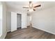 The bedroom has gray wood floors, ceiling fan, and a walk-in closet for storage at 20184 Sw 57 St, Dunnellon, FL 34431