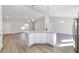 Kitchen island with granite countertop and pendant lighting opens to the living area at 20184 Sw 57 St, Dunnellon, FL 34431