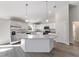 Bright kitchen boasts stainless appliances, granite countertops, and an island with pendant lighting at 20184 Sw 57 St, Dunnellon, FL 34431
