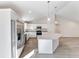 Bright kitchen boasts stainless appliances, granite countertops, and an island with pendant lighting at 20184 Sw 57 St, Dunnellon, FL 34431