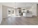 Open floorplan with the kitchen featuring an island and stainless appliances, open to living and dining area at 20184 Sw 57 St, Dunnellon, FL 34431