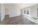Open living room with wood-look floors and French doors leading to the outside at 20184 Sw 57 St, Dunnellon, FL 34431