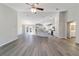 Open-concept living space with grey flooring flowing into a bright white kitchen with a center island at 20184 Sw 57 St, Dunnellon, FL 34431