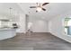 Open-concept living area with gray vinyl floors, light walls and modern white trim at 20184 Sw 57 St, Dunnellon, FL 34431