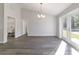 Open living room with wood-look floors and French doors leading to the outside at 20184 Sw 57 St, Dunnellon, FL 34431