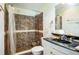 Bathroom with black marble vanity countertop and walk-in shower at 2486 Daytona Park Rd, Deland, FL 32724
